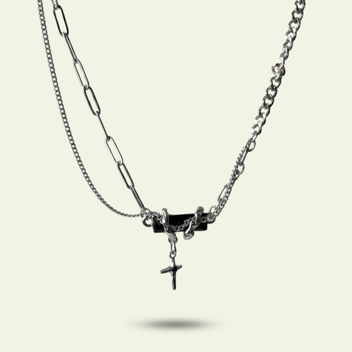 Double-layered necklace with chain and pendant on a light beige background