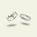 Two silver rings with a pink gemstone on a light gray background