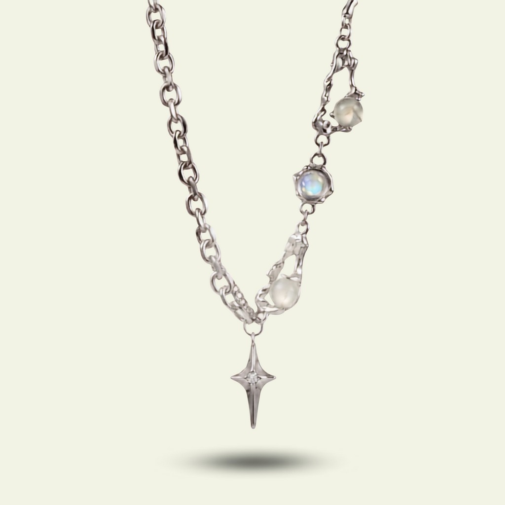 Silver necklace with star-shaped pendant on a light gray background