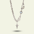 Silver necklace with star-shaped pendant on a light gray background
