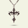 Silver cross pendant necklace on a light beige background
