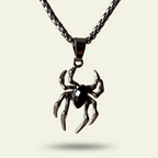 Spider-shaped pendant on a chain against a light background