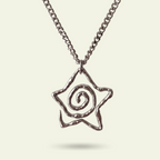 Silver necklace with a spiral pendant on a light beige background