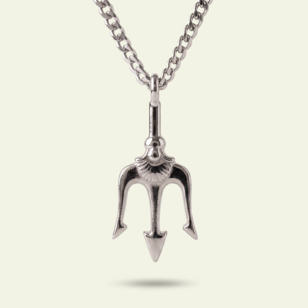 Silver trident pendant on a chain against a light background