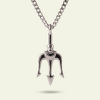 Silver trident pendant on a chain against a light background