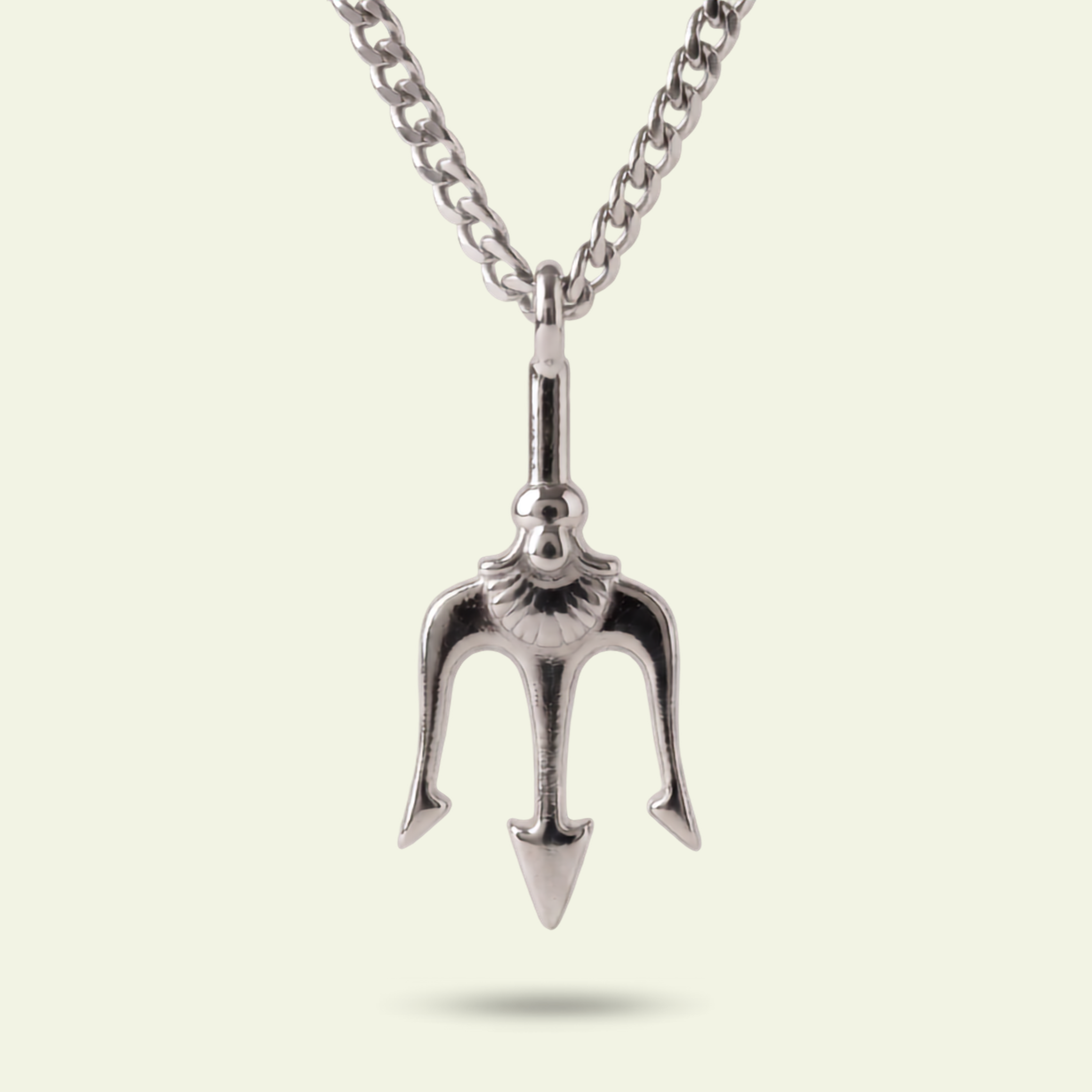 Silver trident pendant on a chain against a light background
